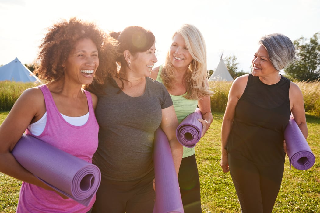 Group of Mature Female Friends on Outdoor Yoga Retreat Walking a